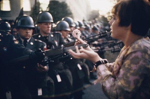 1. 17 yaşındaki Jan Rose Kasmir 1967 yılında Pentagon savaş karşıtı protestoları sırasında askerlere çiçek sunuyor.