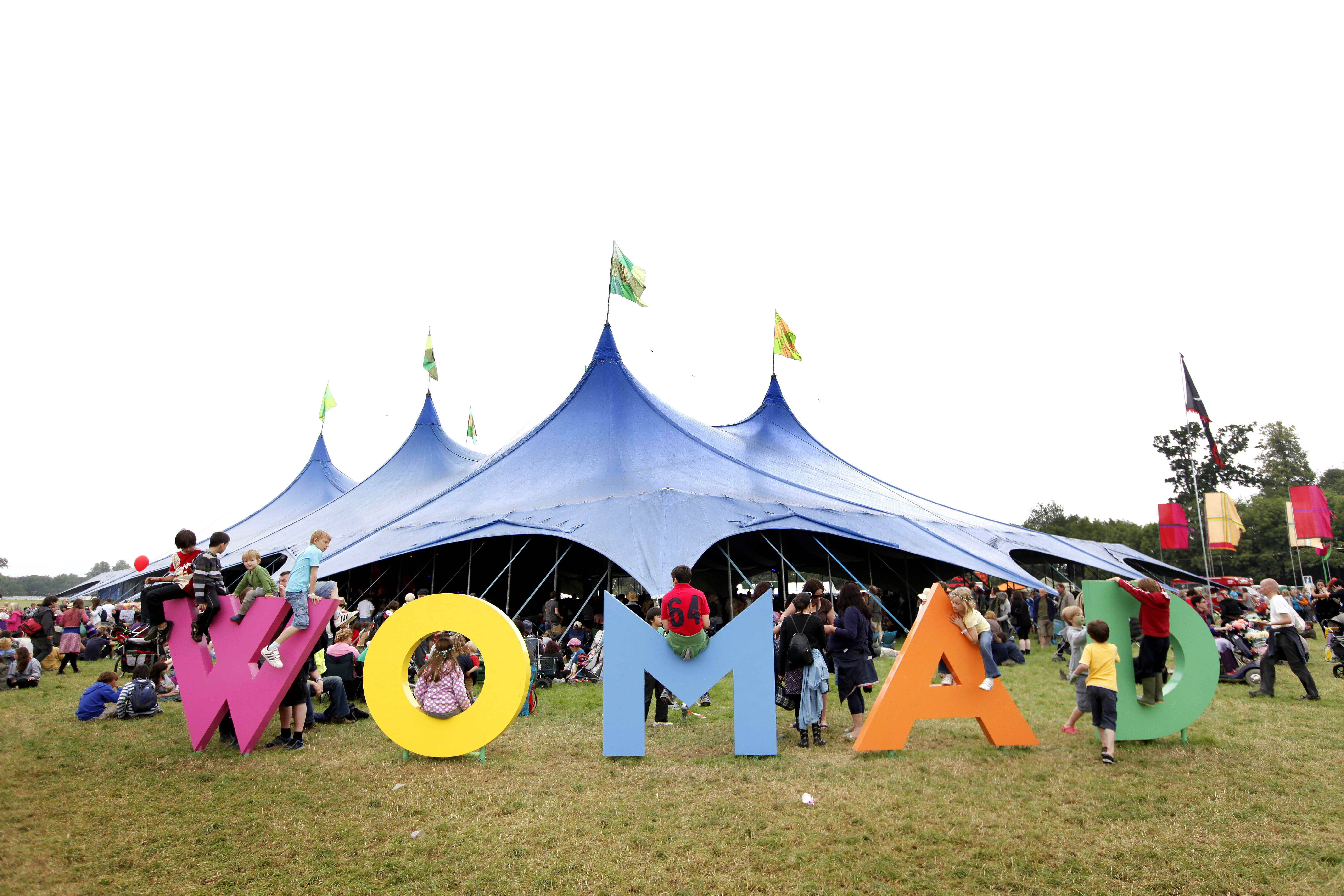 Фестиваль озон. WOMAD фестиваль. WOMAD Festival in Britain. Этнические фестивали оформление. Атрибутика спортивных фестивалей.