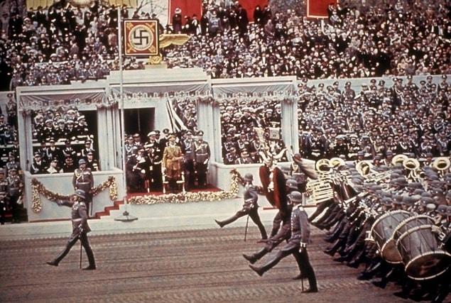 21. German troops goose-step past the reviewing stand during a massive rally and military parade in celebration of  Hitler's 50th birthday, Berlin, 1939.