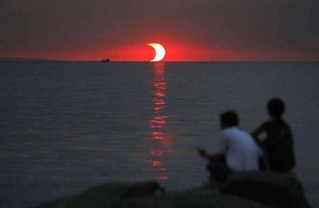 3. A lunar eclipse and sunset happening at the same time