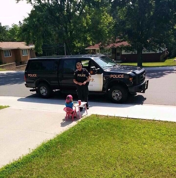 6. Офицер полиции остановился, чтобы отведать вкусного лимонада у маленькой девочки.