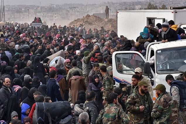 2. Syrian families fleeing eastern Aleppo line up to board government buses heading to government-controlled western Aleppo on Nov. 29.