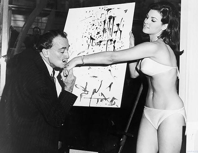 3. Salvador Dali Kisses The Hand Of Raquel Welch After Finishing His Famous Portrait Of Her, 1965