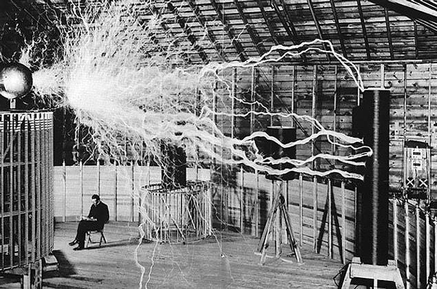 12. Nikola Tesla In His Laboratory, Sitting Behind His “Magnifying Transmitter”