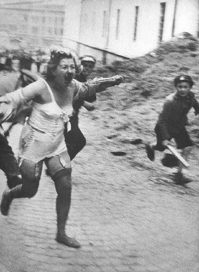 6. A Jewish woman chased by men and youth armed with clubs during the Lviv pogroms, 1941.