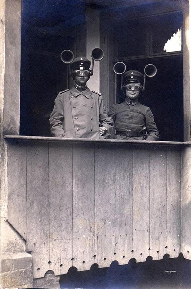 11. Two military officers who are wearing audio sensors in order to spot the rival flights in the air space.