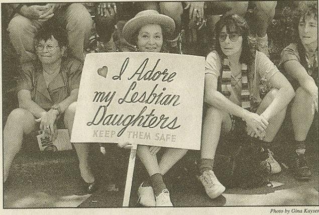 This newspaper image showing a woman holding a sign that reads “I adore my lesbian daughters. Keep them safe” has been floating all around the internet for quite some time now — maybe you’ve seen it?