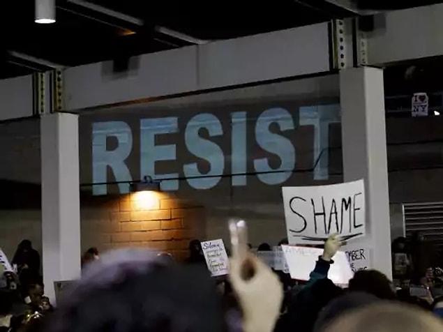 The protesters sentiments has been projected onto a wall of the JFK International Airport on Saturday.