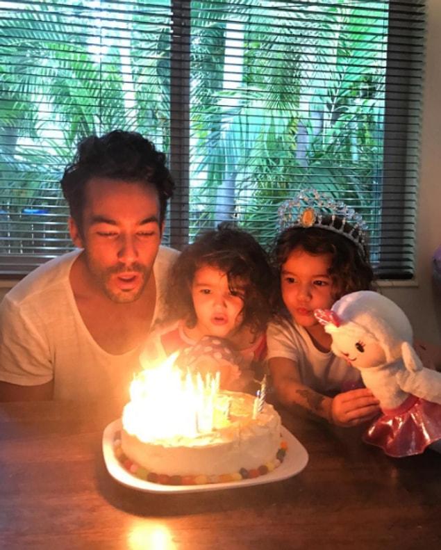 28. And blowing out some birthday candles with both of his little girls.