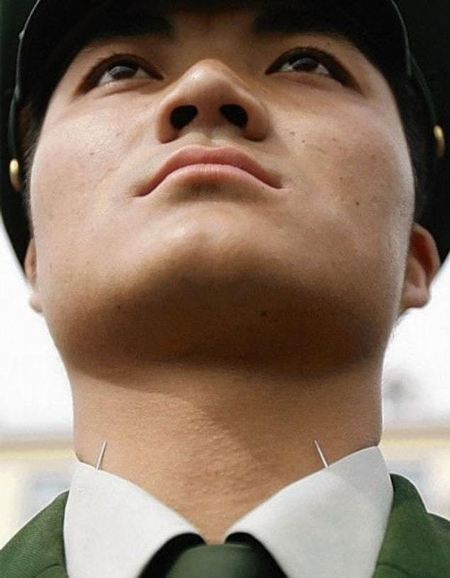 5. The pin in the picture has been placed just below the chin of a soldier in the Chinese army during training so that his chin remains straight; the pin also prevents the soldier from falling asleep from exhaustion.