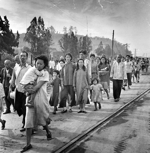 13. Refugees, mostly Chinese, retreat from the ruins of Inchon, a key port that was bombarded and invaded by American forces in September 1950.