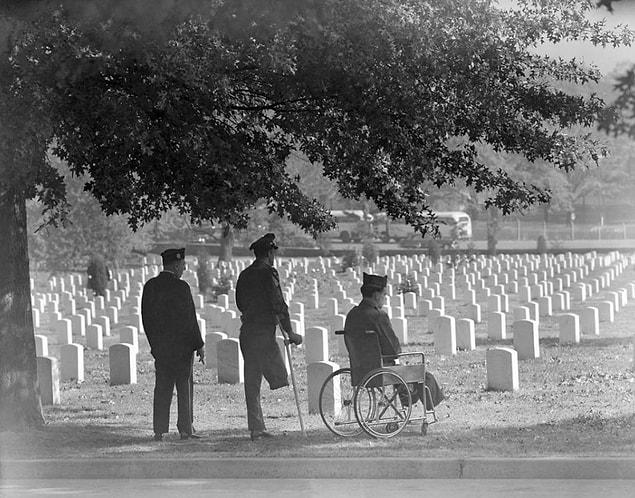 23. Overlooking headstones on Armistice Day, a group of both WWII and Korean War veterans pay their respects in 1951.
