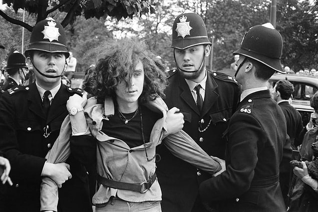 13. A young Piccadilly squatter is evicted by London police in 1969.