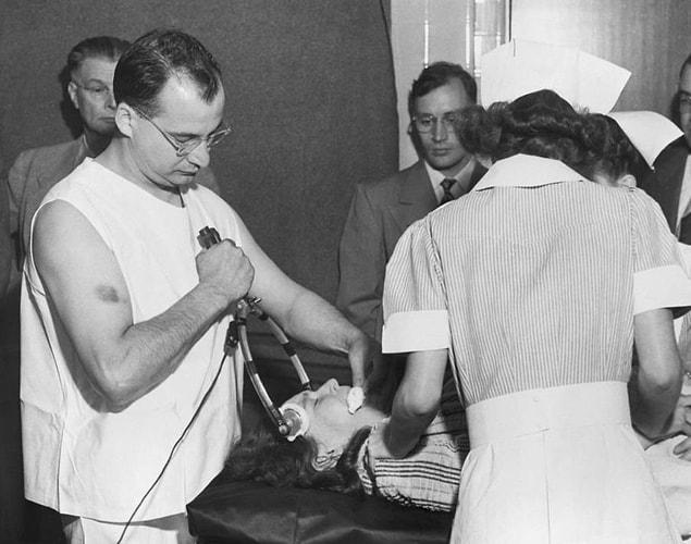 20. Dr. James G. Shanklin administers electric shock and anesthesia in preparation for Dr. Walter Freeman to demonstrate his new transorbital lobotomy procedure at Western State hospital in Lakewood, Washington on July 11, 1949.