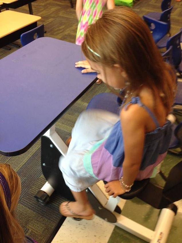 13. This first grade classroom has desks with pedals so kids can move while learning.