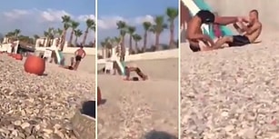 Plajda, İnsanların Meraklı Bakışları Arasında Tekerlek Hareketi Yapan İkili