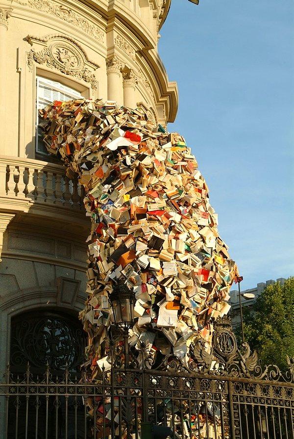 2. Alicia Martin tarafından yapılmış, bir binadan dökülen 5000 kitabı gösteren sanat eseri. 📚