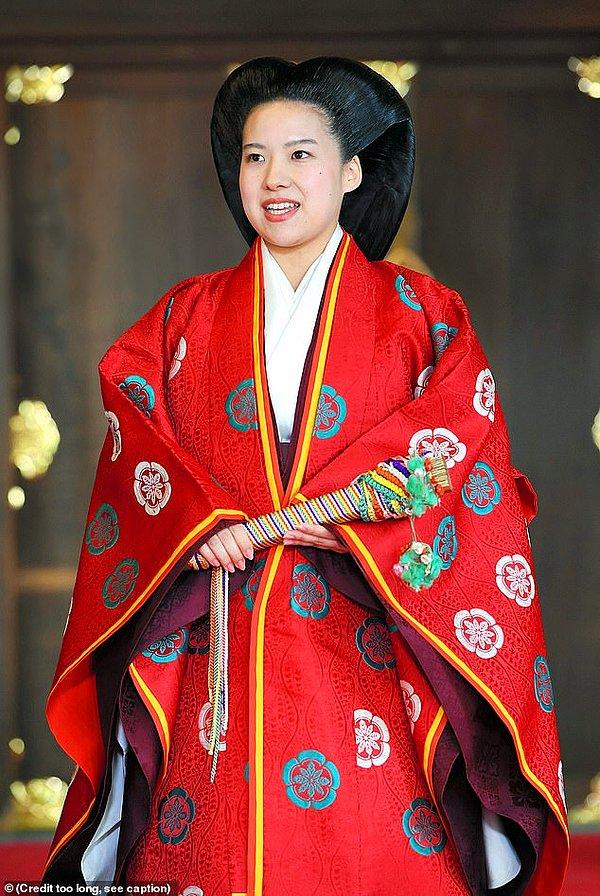 Gelin daha sonra kırmızı bir geleneksel Japon kaftan ile kıyafetini değiştiriyor.