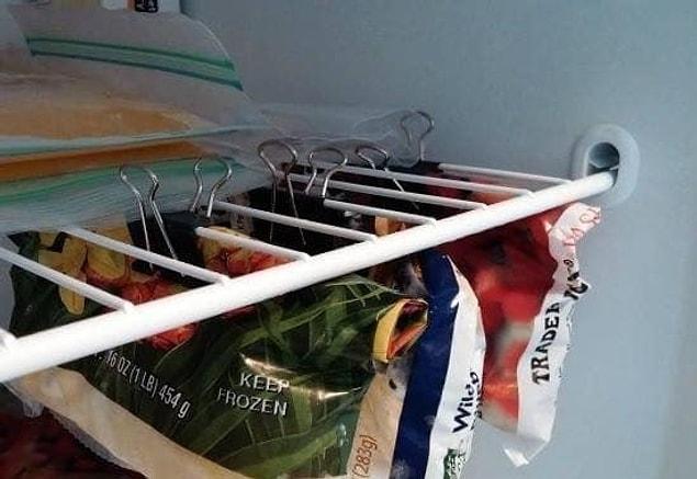 9. Use binder clips to hang up your bags of frozen veggies, like this: