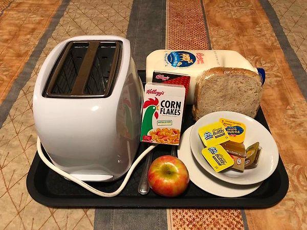 16. "A motel served me this breakfast tray for $15 and contains a toaster, and a 2L milk."