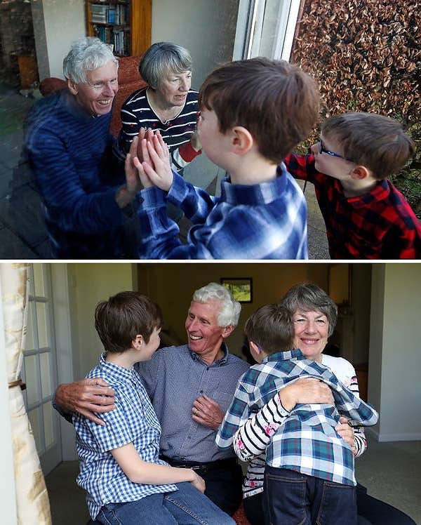 15. Бабушка и дедушка навещают своих внуков через стеклянное окно во время пандемии и обнимают их впервые за год после вакцинации: