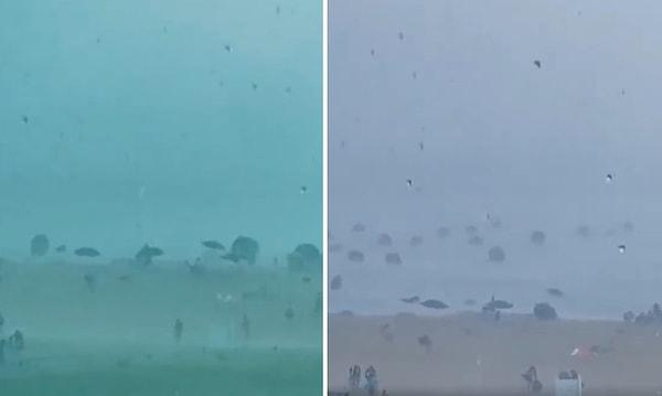 Bir plajda kaydedilen görüntülerde, yüzlerce şemsiye denize uçarken görülüyor.