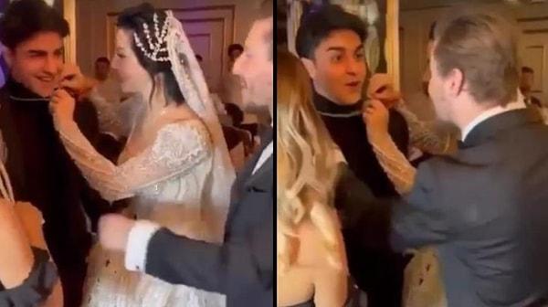 Sosyal medyaya düşen yeni bir görüntüde, Merve Boluğur-Mert Aydın çiftinin düğüne eli boş gelen TikToker Cellat'ın boynundaki altın kolyeyi aldıkları görülüyor.