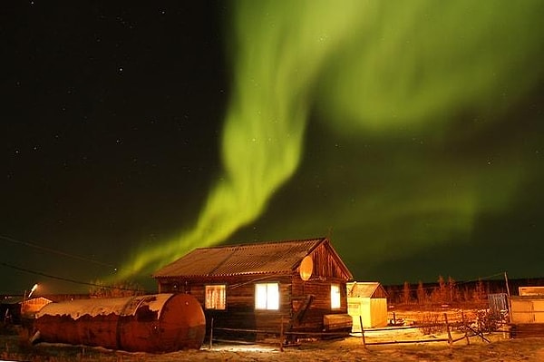 When charged particles of the 'solar wind' (the continuous flow of charged particles from the Sun's corona into space) hit the Earth's magnetic field, they travel along it.