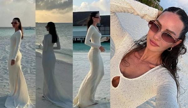 Şimdi de tüm plajın yerlerini süpüren beyaz elbisesiyle çok beğenildi.