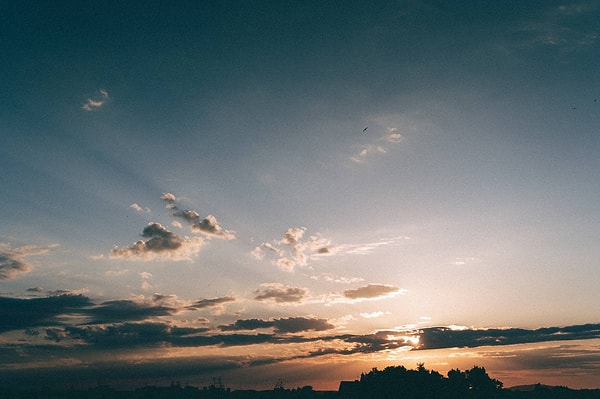 The blue color of the sky can be explained by the interaction between sunlight and the gases and particles in the atmosphere, where shorter wavelengths scatter more.