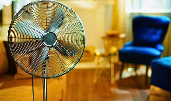 Fans do not eliminate the heat in a room; they merely facilitate the evaporation of sweat on our skin by stirring the air.