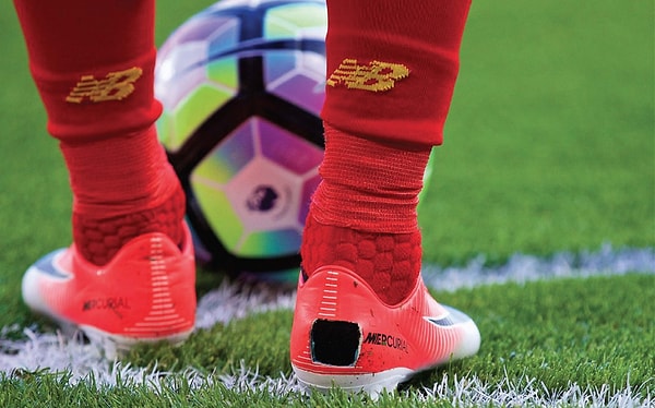 The reason why football players cut their cleats is due to an involuntary bone growth in their feet.